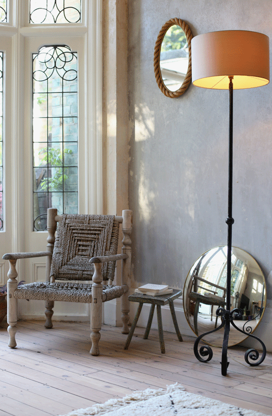 Bring the outside in, beautiful leaded windows in Hannah's flat featuring a mid-cenury rope chair and a wrought iron table lamp.