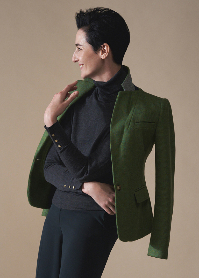 Model Erin O'Connor photographed wearing a Hobbs tailored wool tweed jacket over a roll neck jumper.