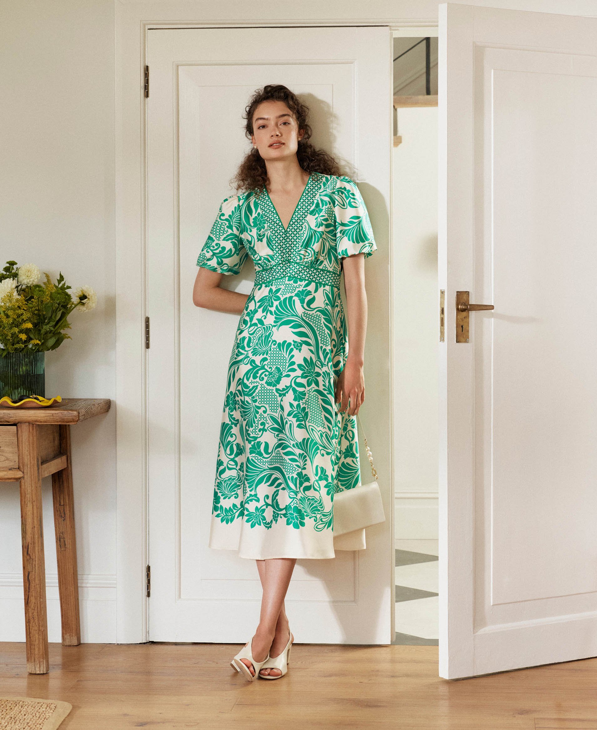A woman wearing a modern paisley print dress.