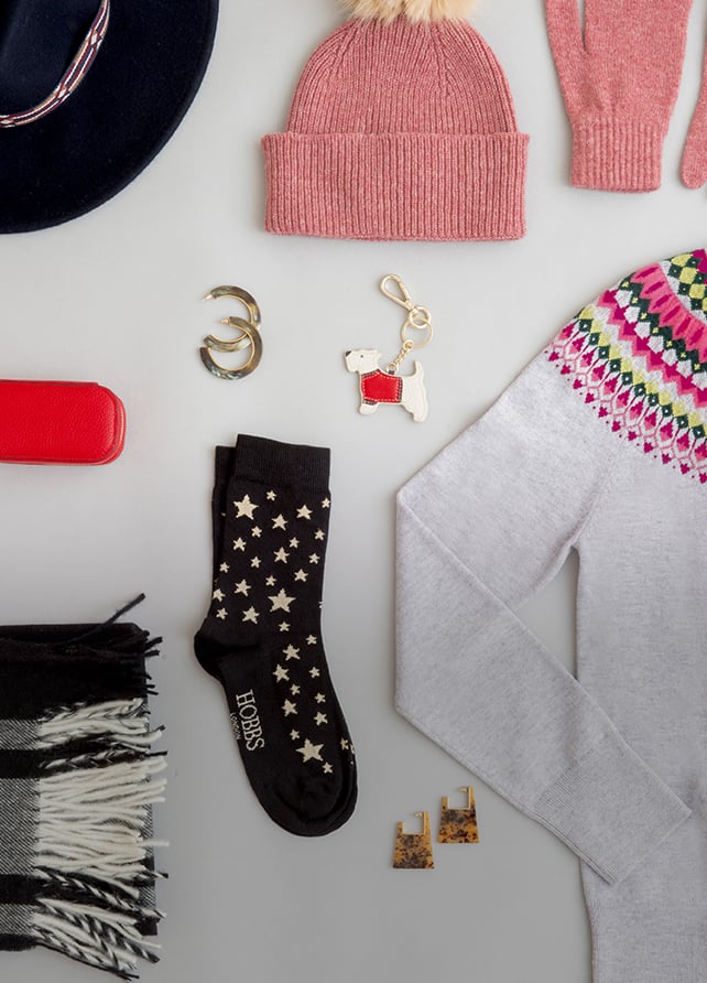 A selection of Christmas gifts including a Fair Isle sweater, check scarf, hat and gloves.