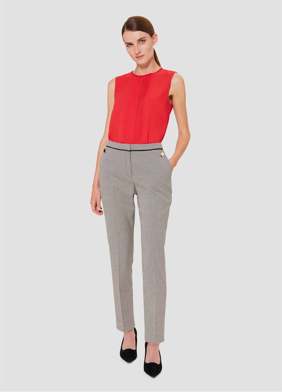 Red top with slim tailored trousers for women worn with black court shoes by Hobbs.