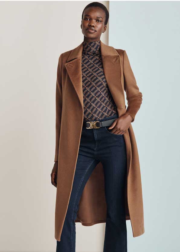 Model photographed wearing a Hobbs tan wool coat with jeans.