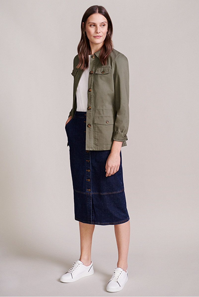 Model wears a field jacket, white tee and button-through denim skirt.