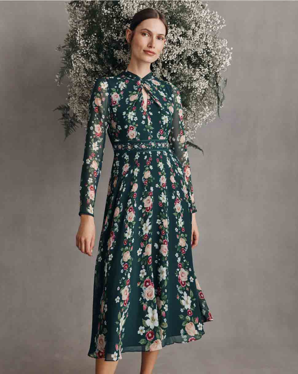 Hobbs models wears a floral print silk midi dress.