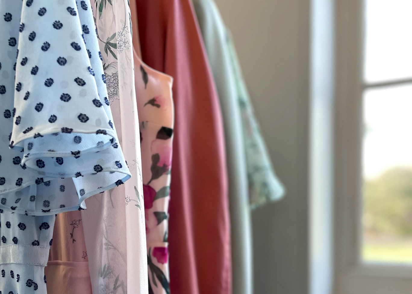 Image of outfits arranged on a rail.