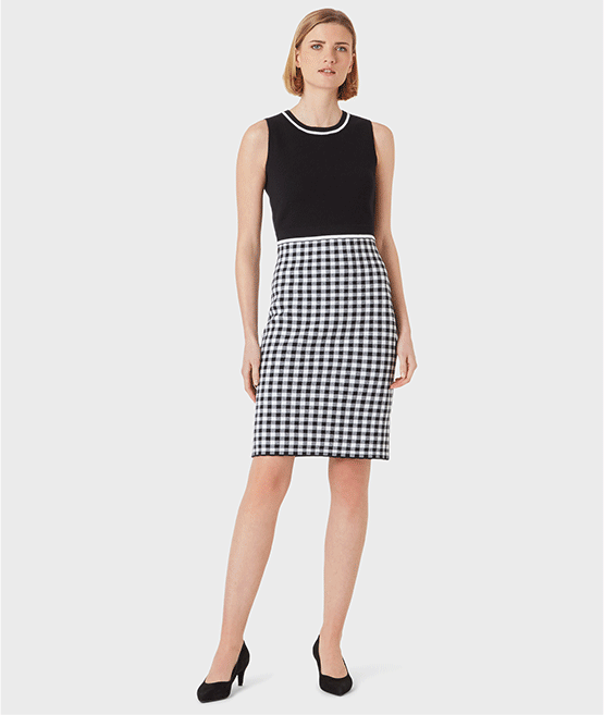 The left shows a sleeveless knitted dress with a gingham print skirt detail in black and white worn with black court shoes, pair with a matching gingham cardigan such as the one shown on the right image to coordinate the look. All from Hobbs.