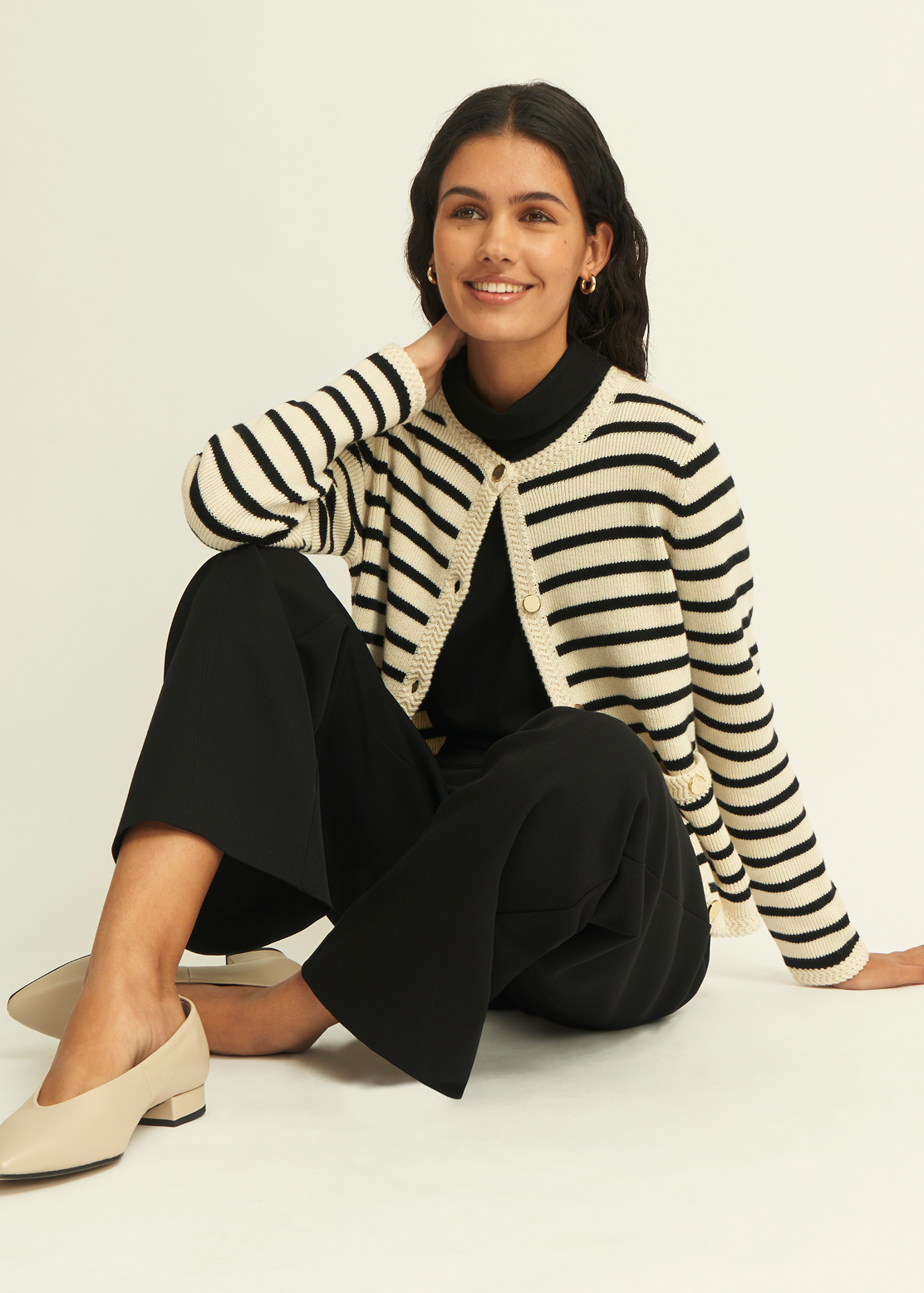 A girl wearing a smart office outfit.