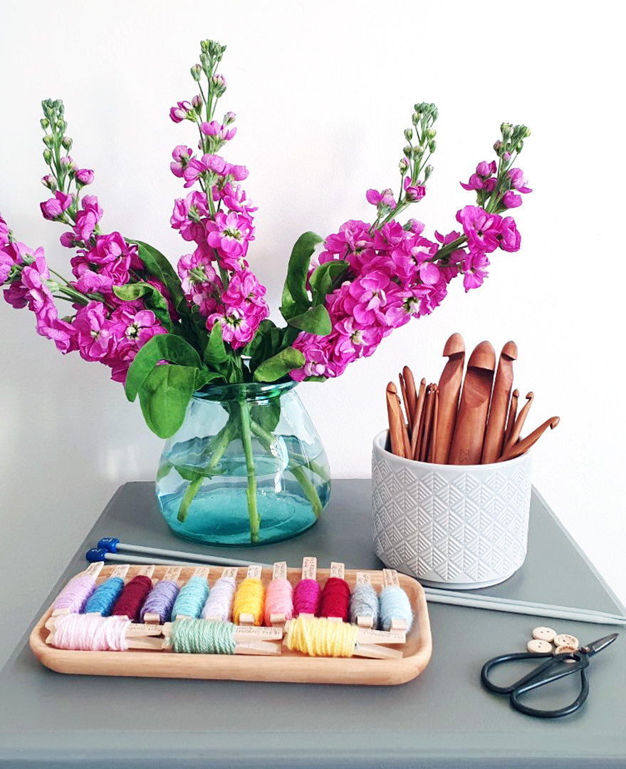 Hobbs Print Designer, Nicole Pope's corchet set at home accompanied by a purple floral arrangement