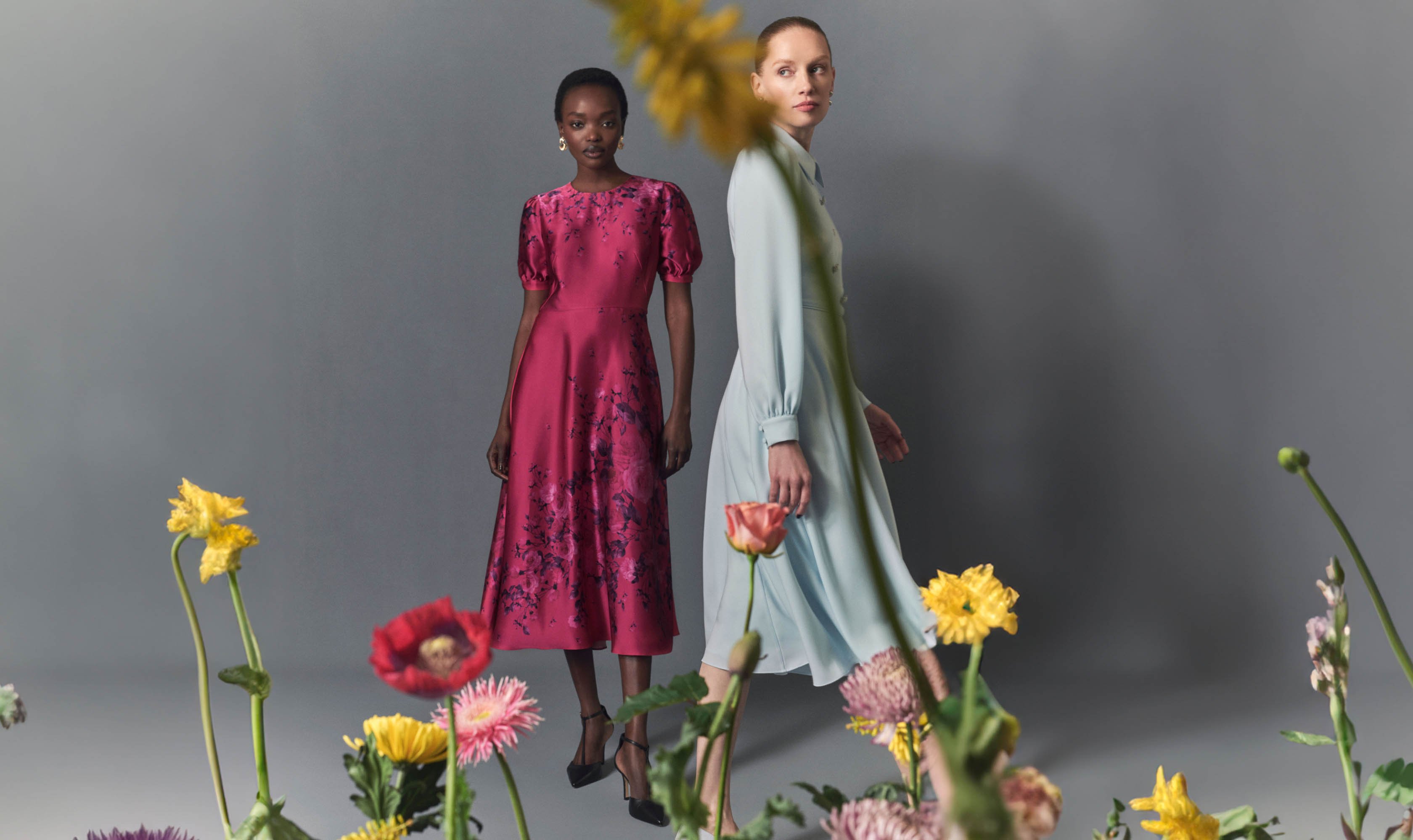 Image of two models wearing occasion dresses.