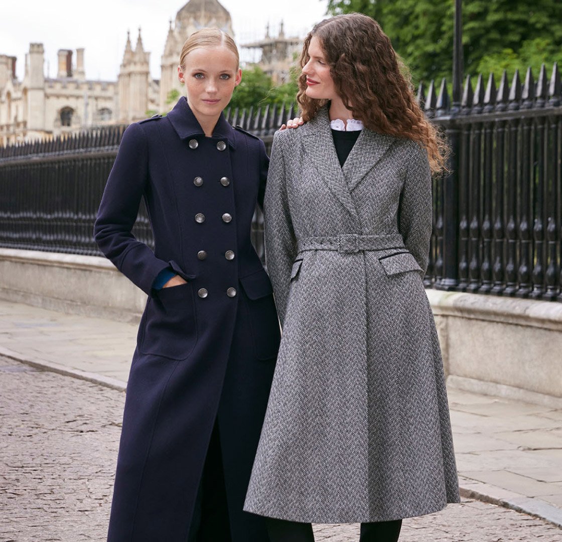 Two models photographed by historic buildings wearing wool coats.