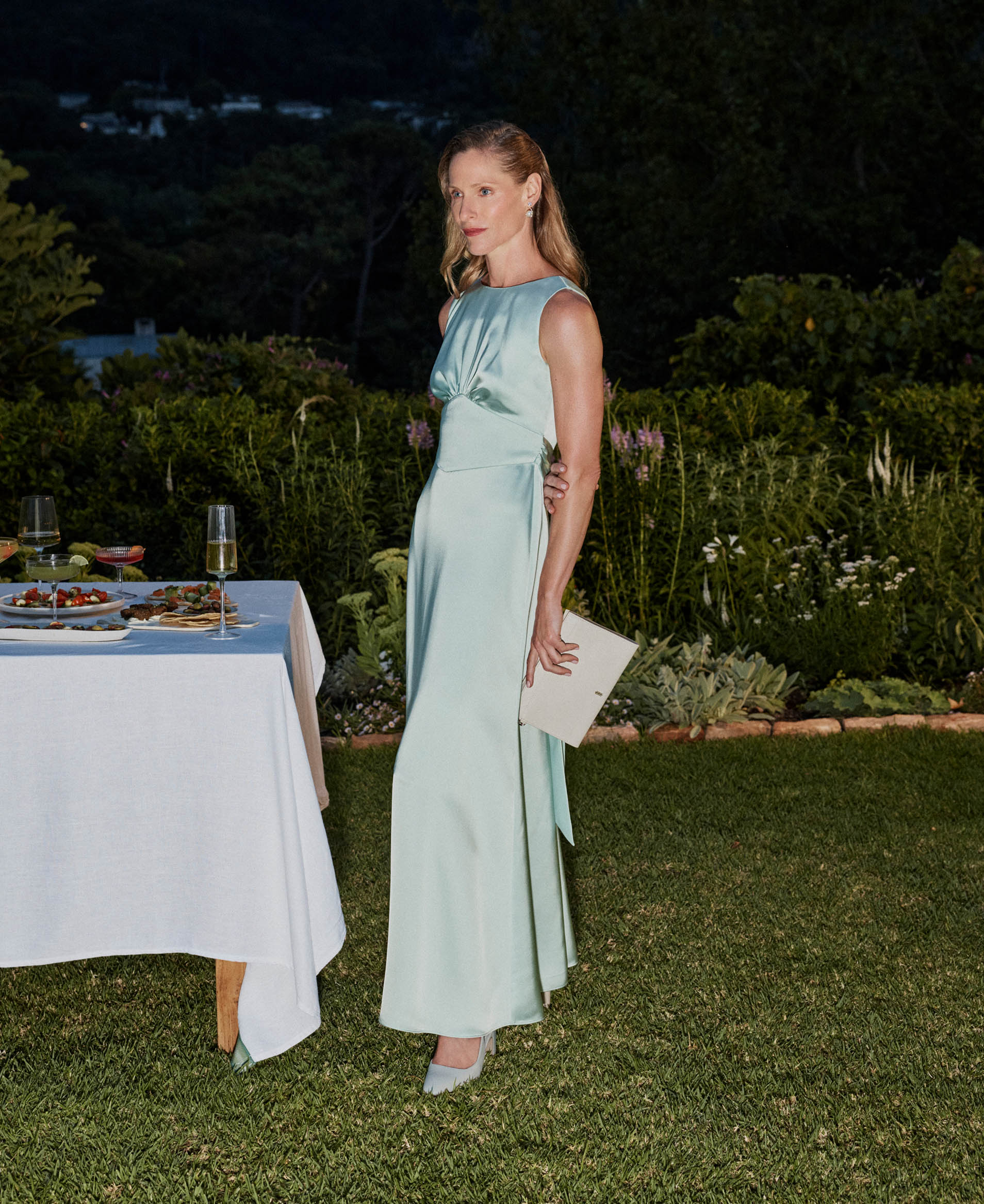 A woman wearing a satin maxi dress.