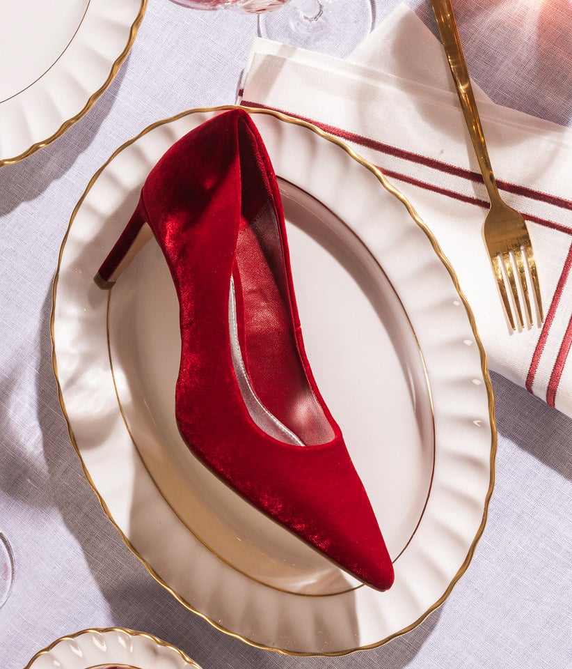 Women wearing chic Christmas party looks in jewel-tone colours.