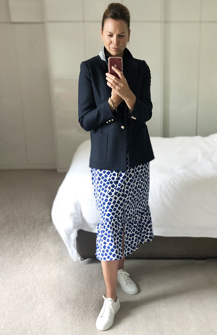 Styled for socialising, Sally teams a blue and whiite shirts dress with a navy blue blazer and white trainers. 