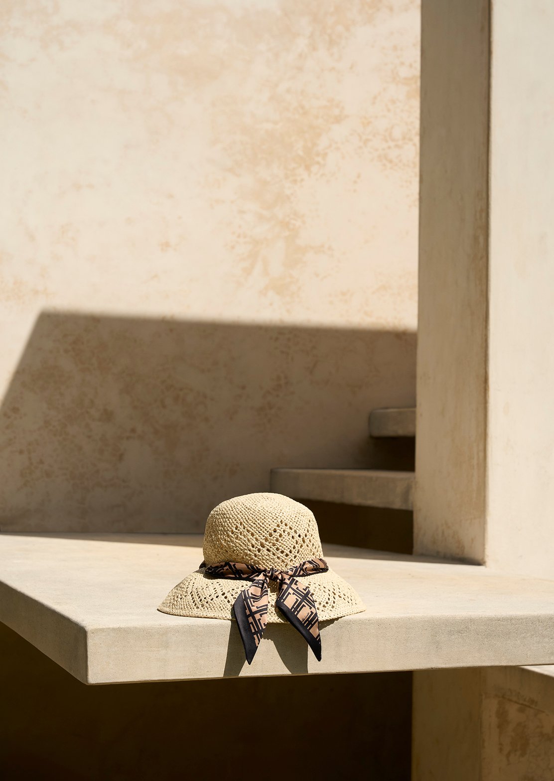 A collage of two images of Hobbs’ sandals and sun hats.
