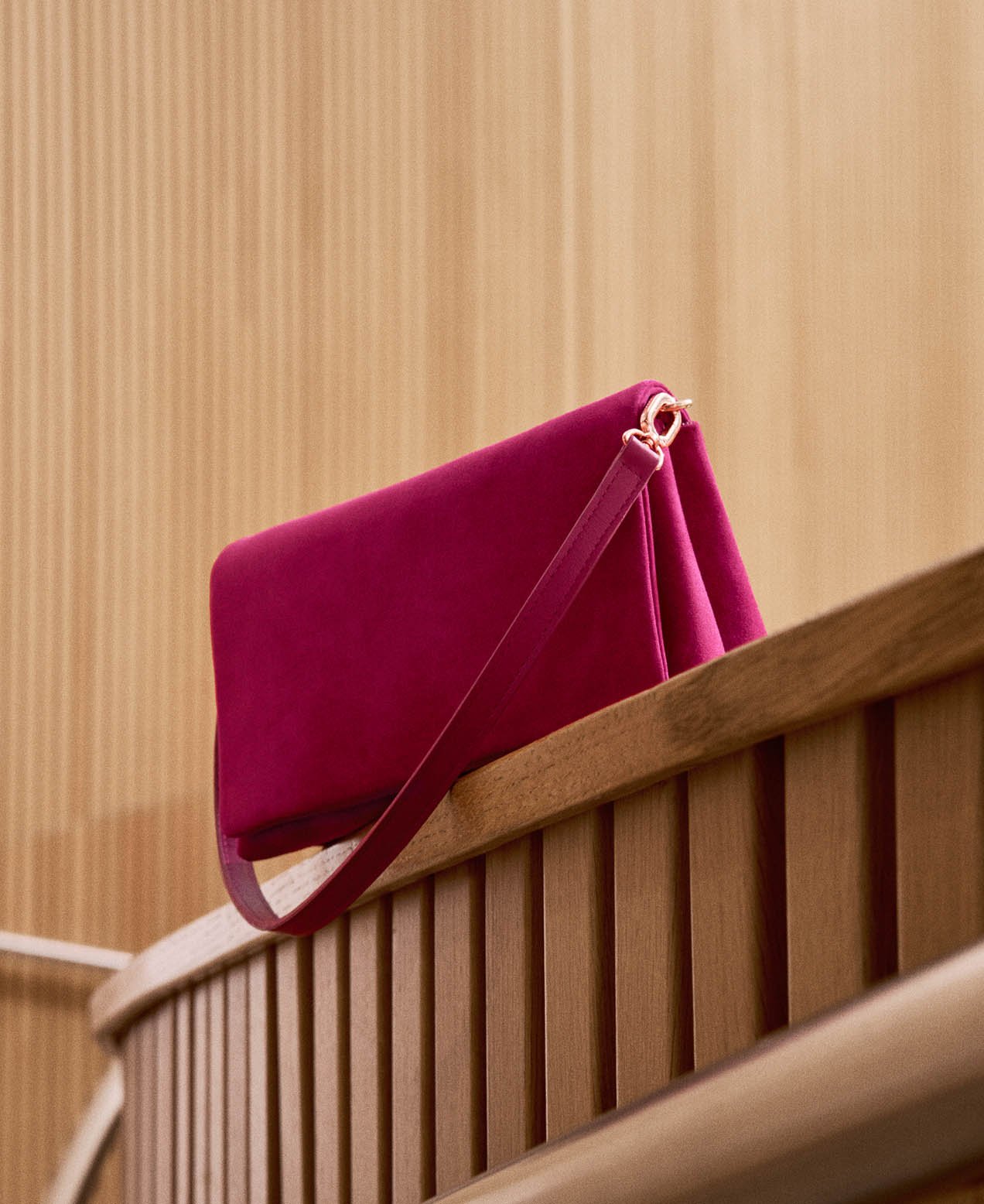 A pink suede clutch bag.
