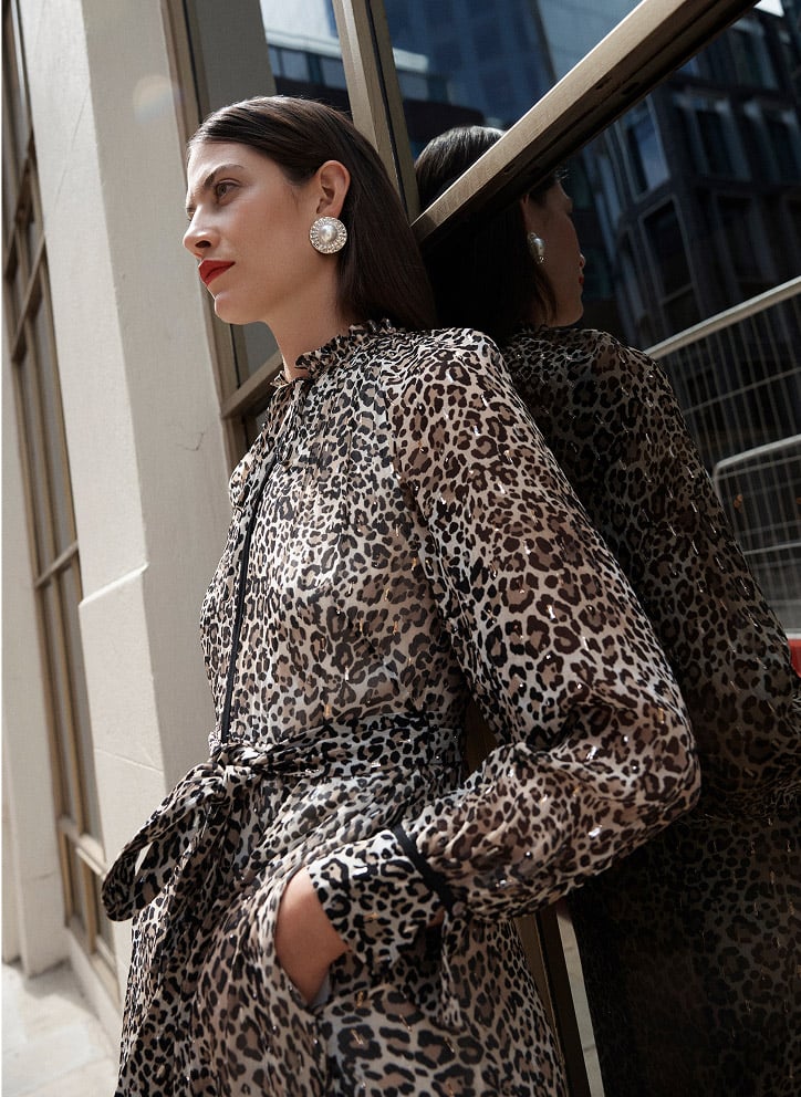 Model photographed in a leopard print dress.