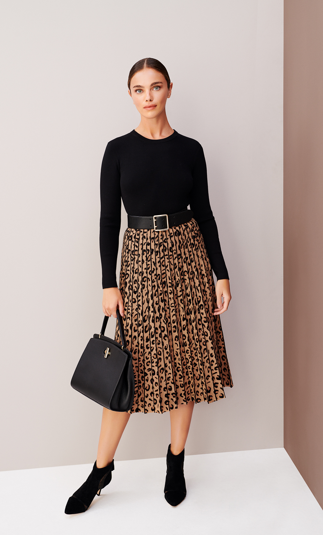 Model wears a knitted leopard print dress with a belt from Hobbs.