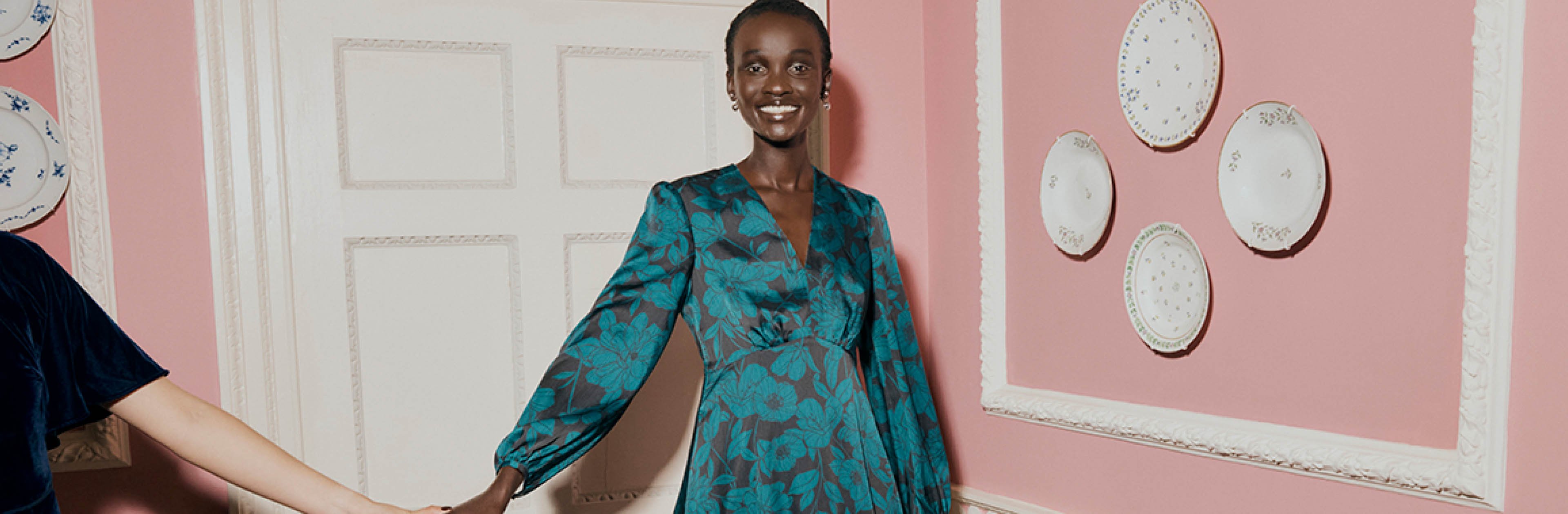 An image of a model wearing a teal satin occasion dress.