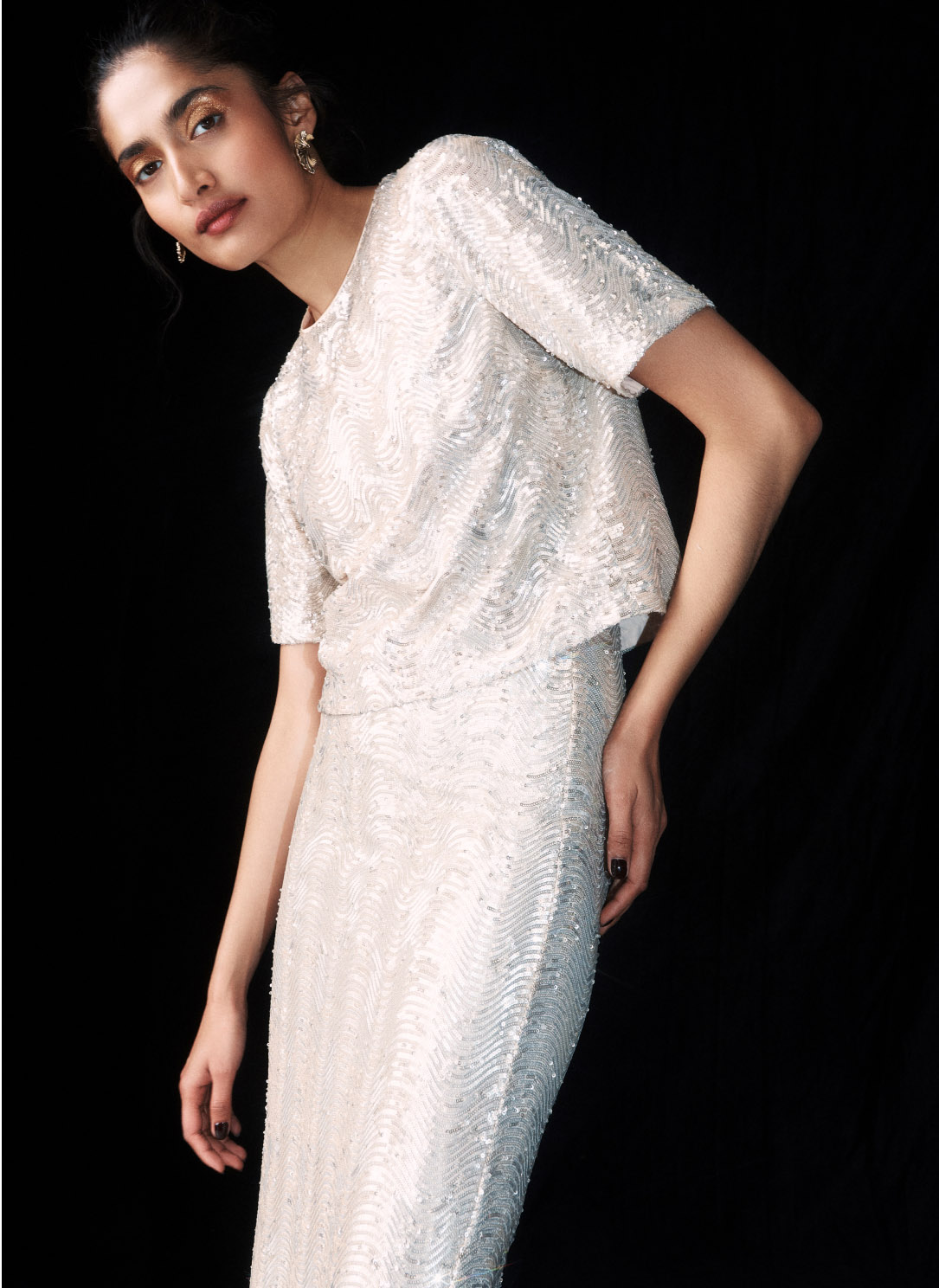 Model photographed in sequin top.