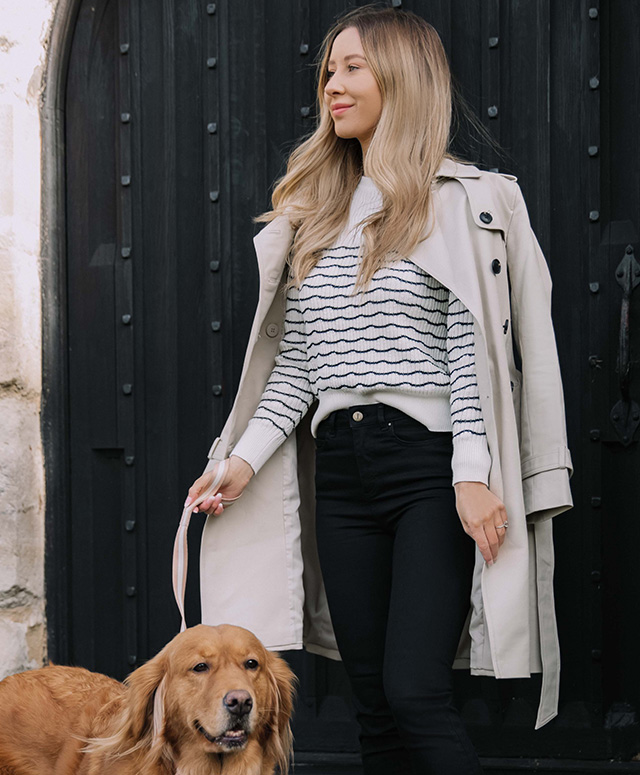 Fashion blogger @shegoeswear photographed on a walk wearing Hobbs Saskia neutral trench, Daniella jumper and Gia black jeans.