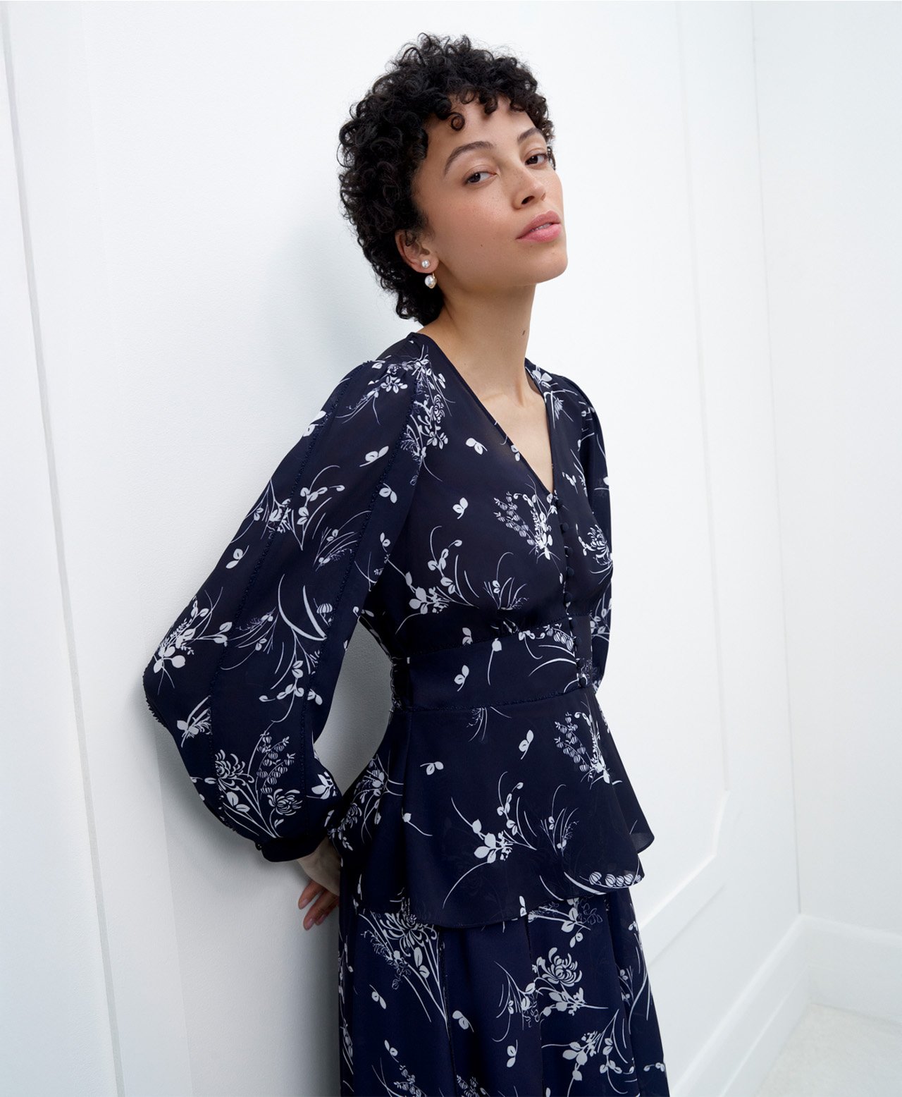 A woman wearing a contemporary, floral, Hobbs occasion co-ord