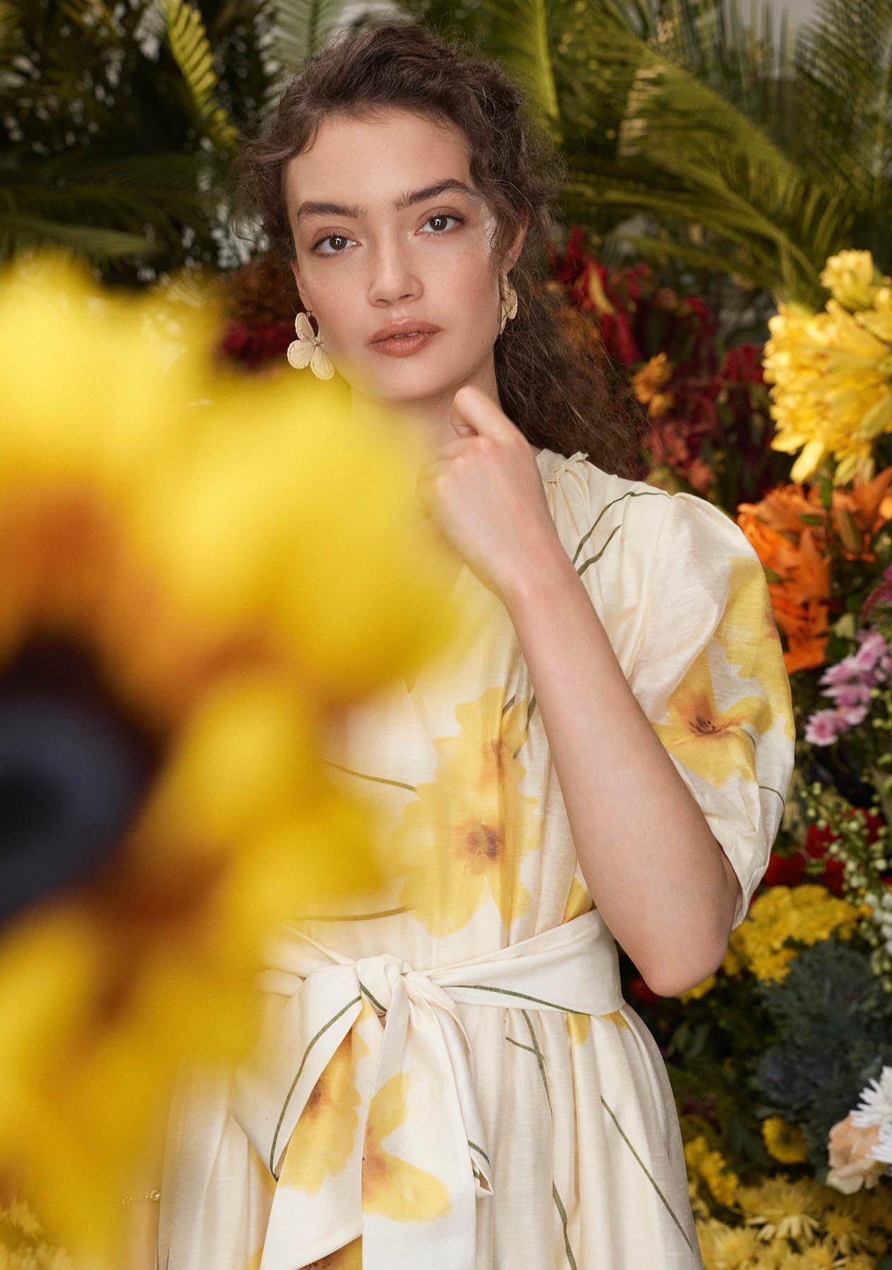 A woman wearing a floral print Hobbs dress.