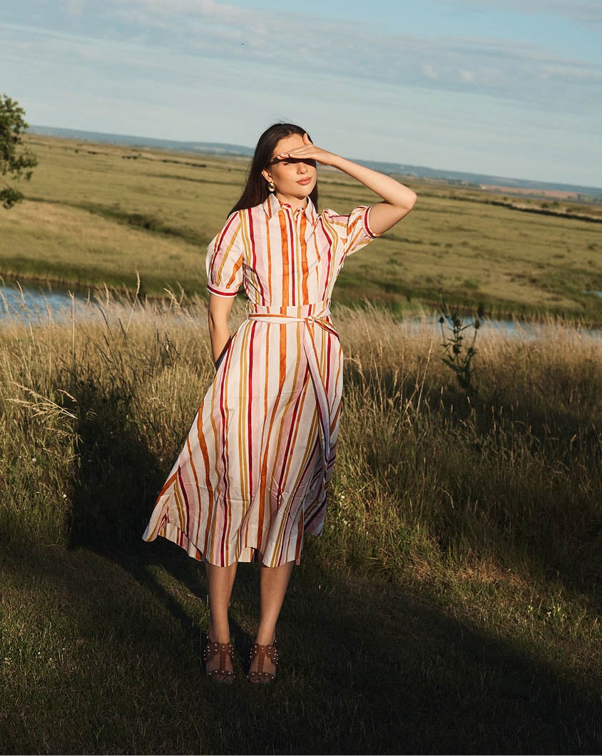 A woman wearing a Hobbs ditsy floral dress.