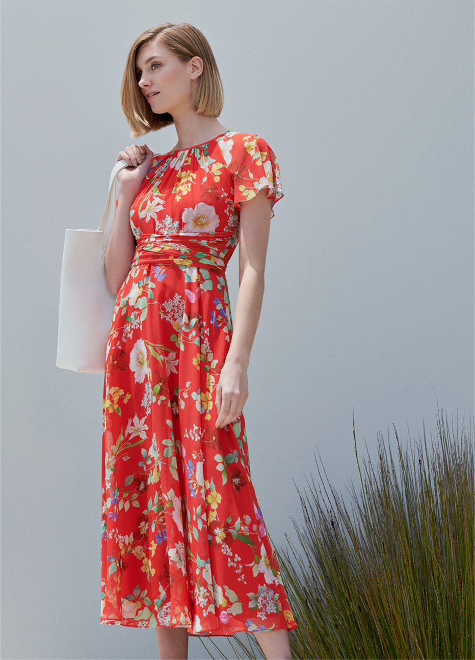 Red floral midi dress with espadrille wedge heels and a white tote bag by Hobbs.