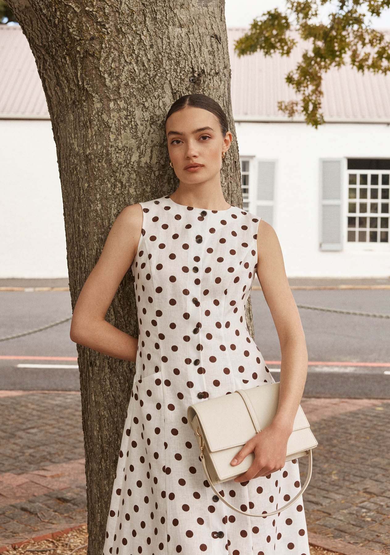 A woman wearing a polka dot Hobbs dress.