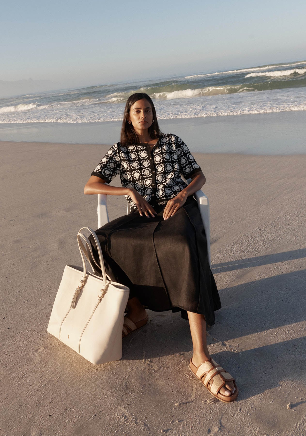 A woman wearing a Hobbs crochet monochrome top.