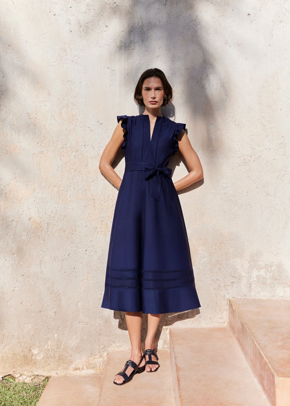 An image of a model wearing a Hobbs’ navy summer dress.