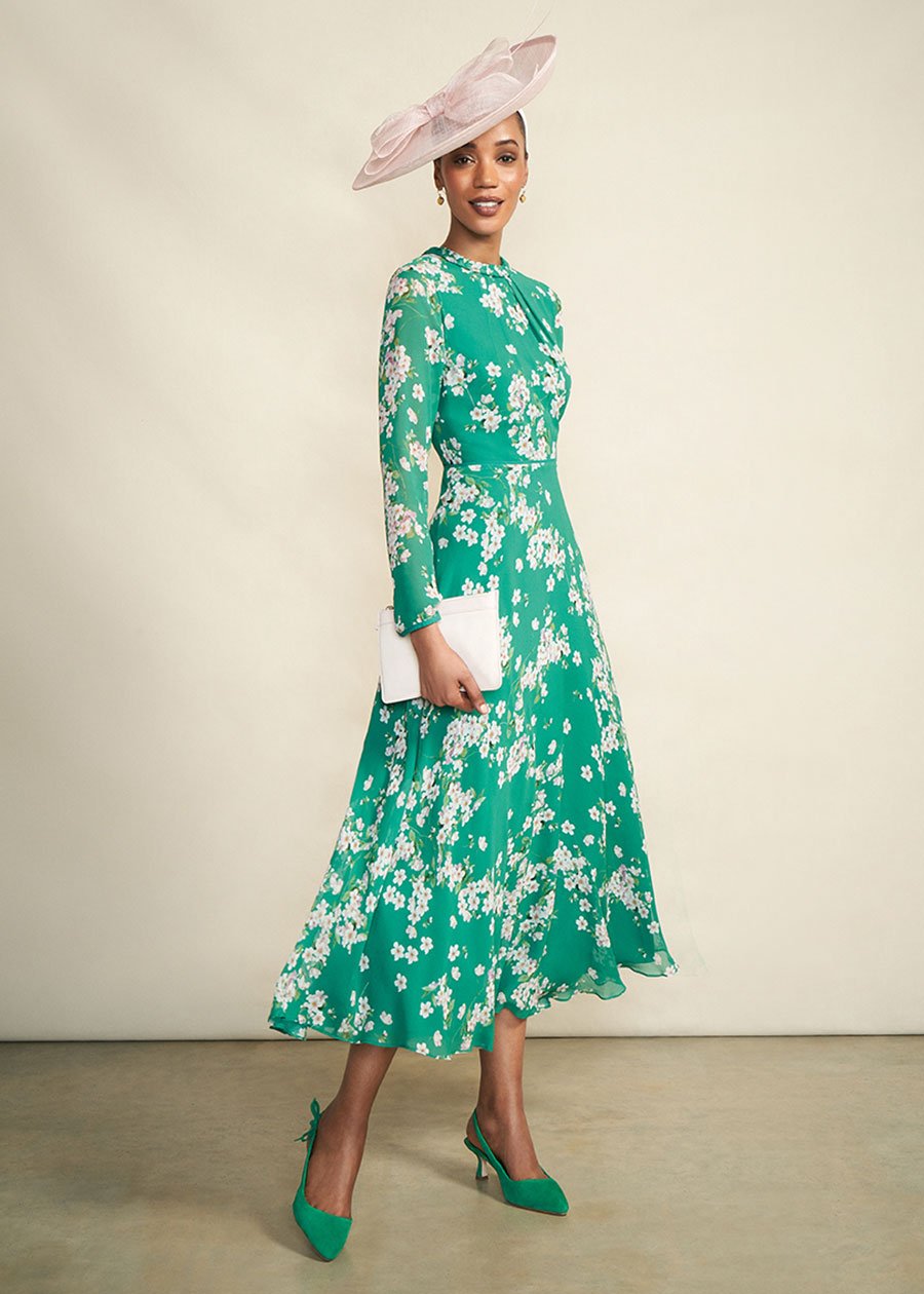 Model photographed against a canvas background wearing a Hobbs floral dress.