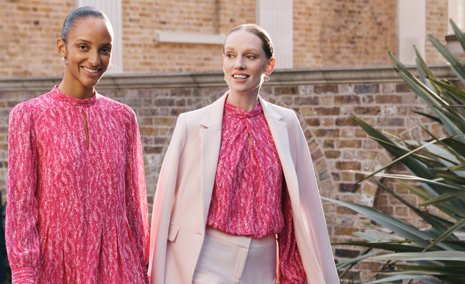 Image of two models arriving at a wedding reception wearing occasion outfits.