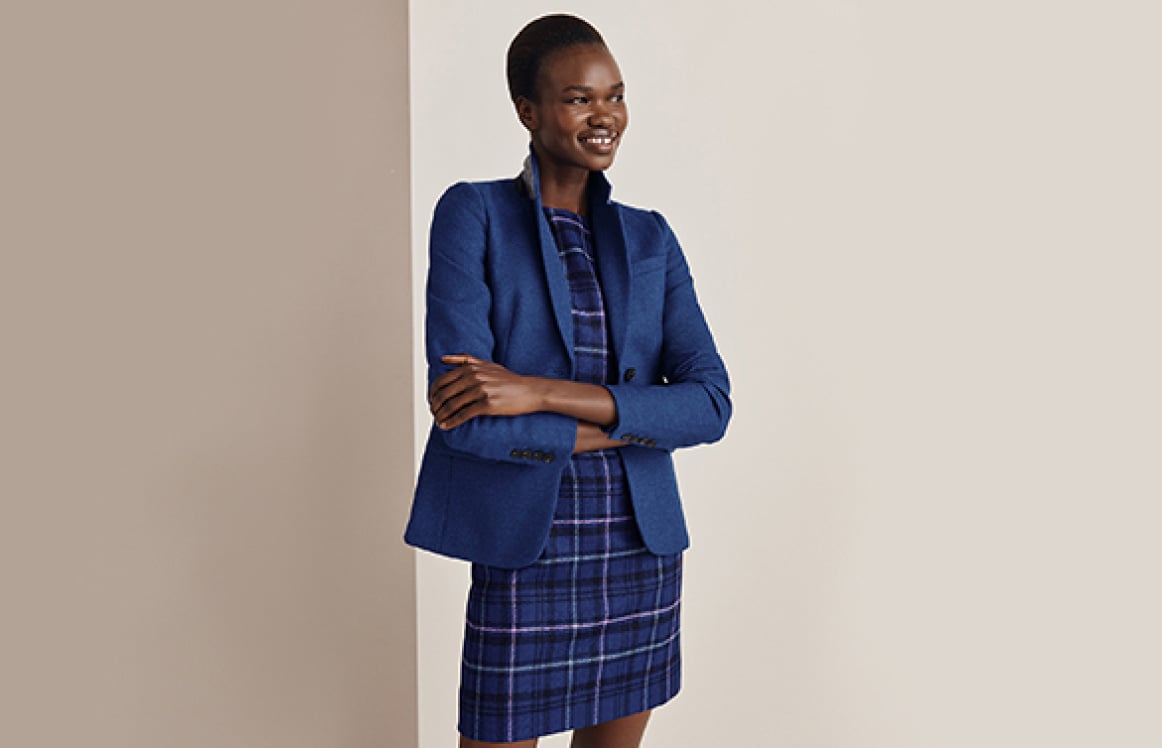 Hobbs model wears a wool blazer over a heritage check dress.