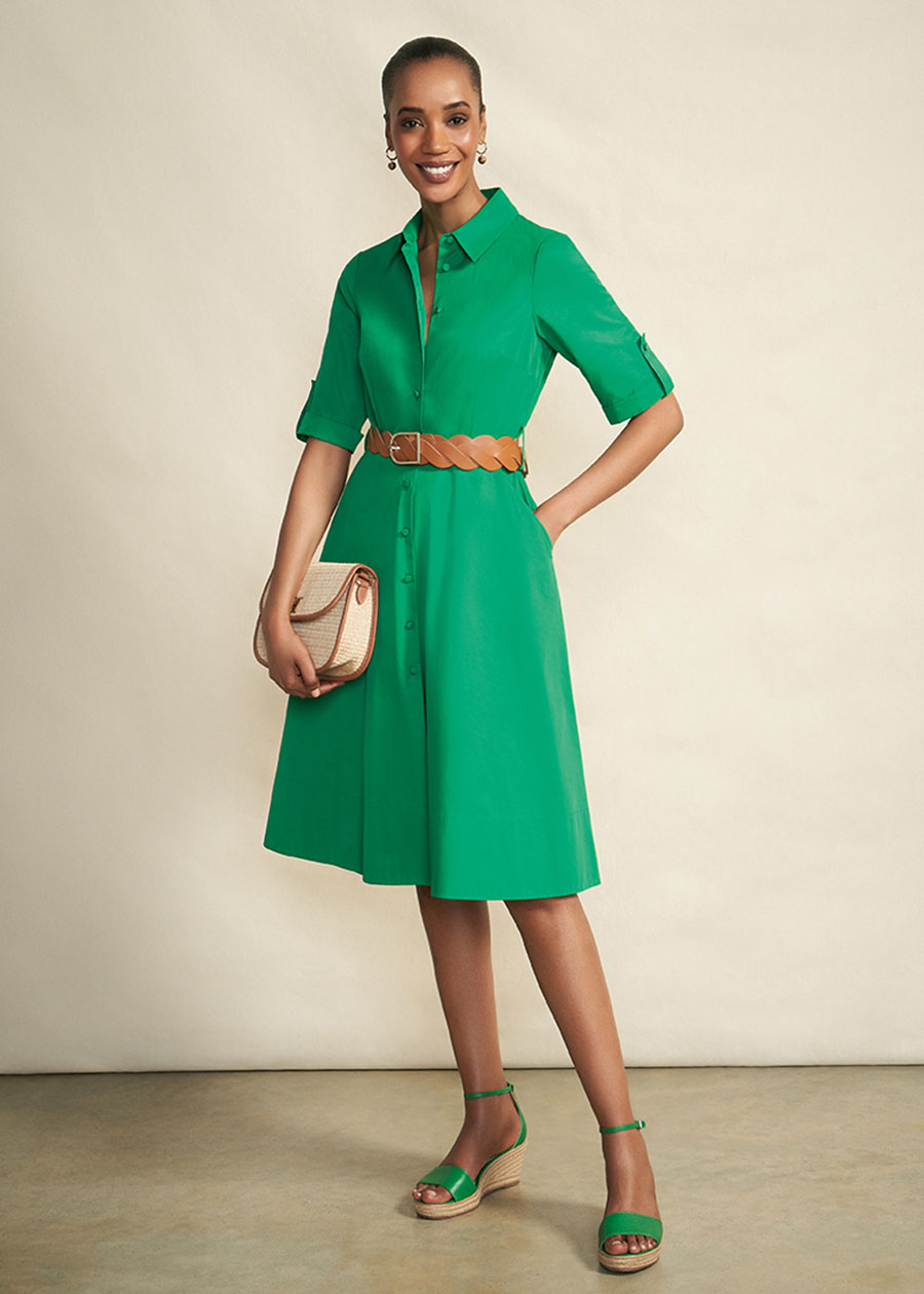 Model photographed against a canvas background wearing a Hobbs green shirt dress.