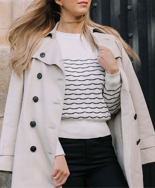 Fashion blogger @shegoeswear photographed on a walk wearing Hobbs Saskia neutral trench, Daniella jumper and Gia black jeans.