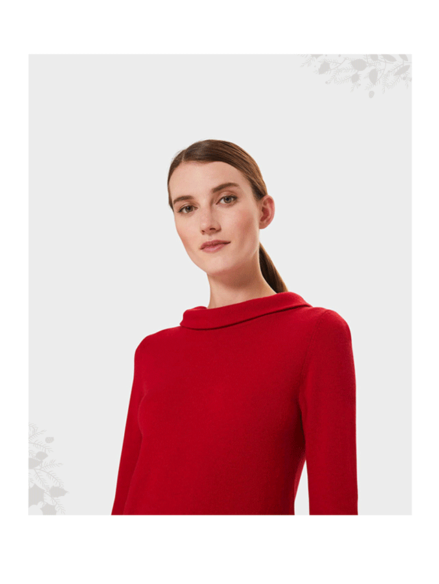 Model wears a red wool jumper with rolled collar from Hobbs.