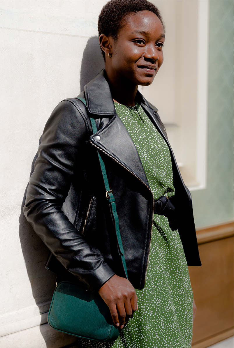 hobbs black leather jacket style with a green floral print dress and ankle boots