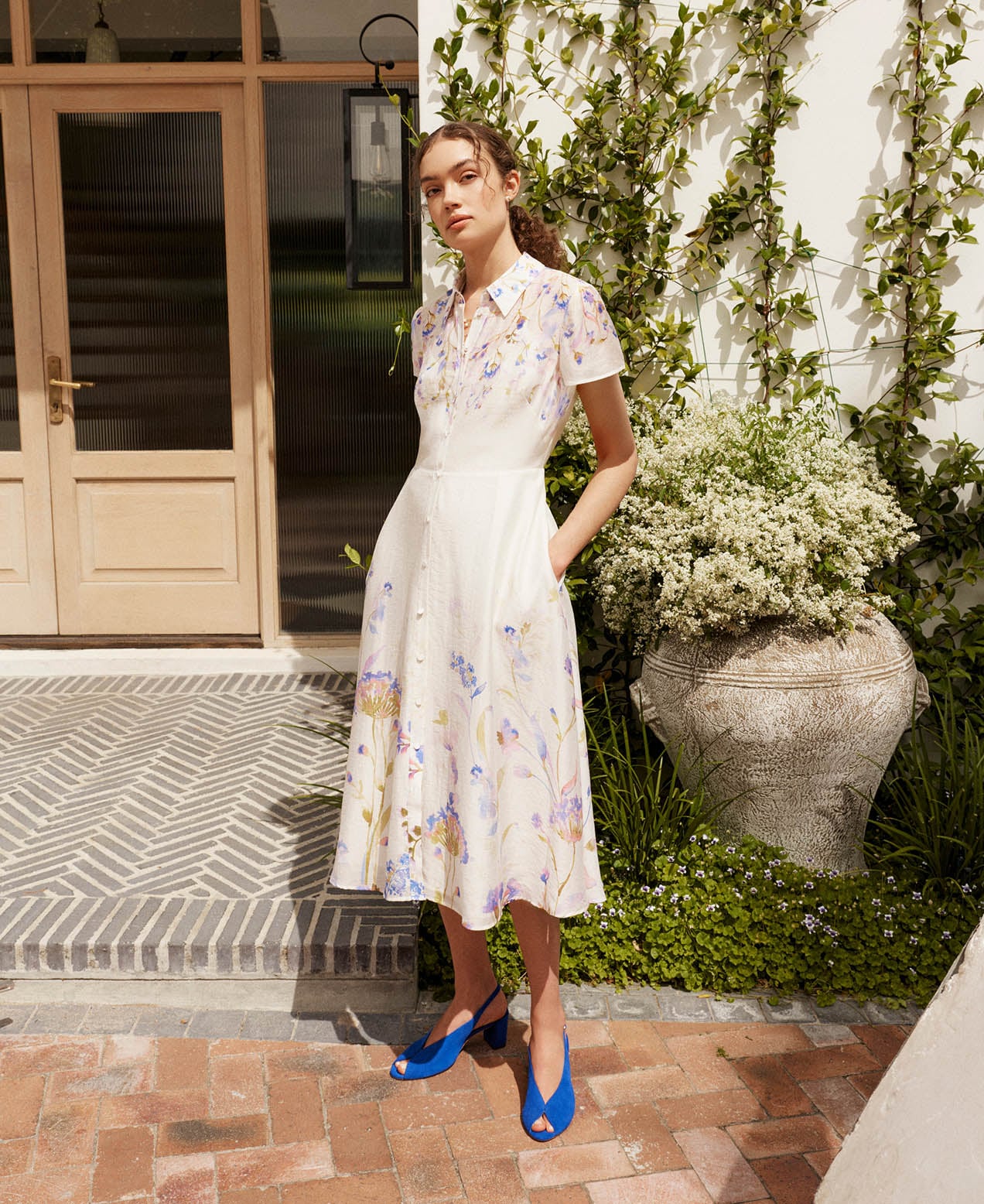 A woman wearing a Hobbs summer dress.