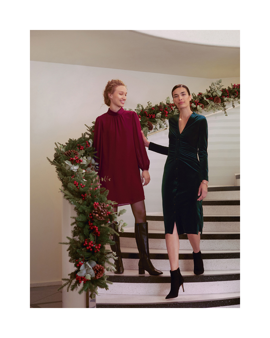 Hobbs models walk down a spiral staircase, wearing velvet dresses and boots.