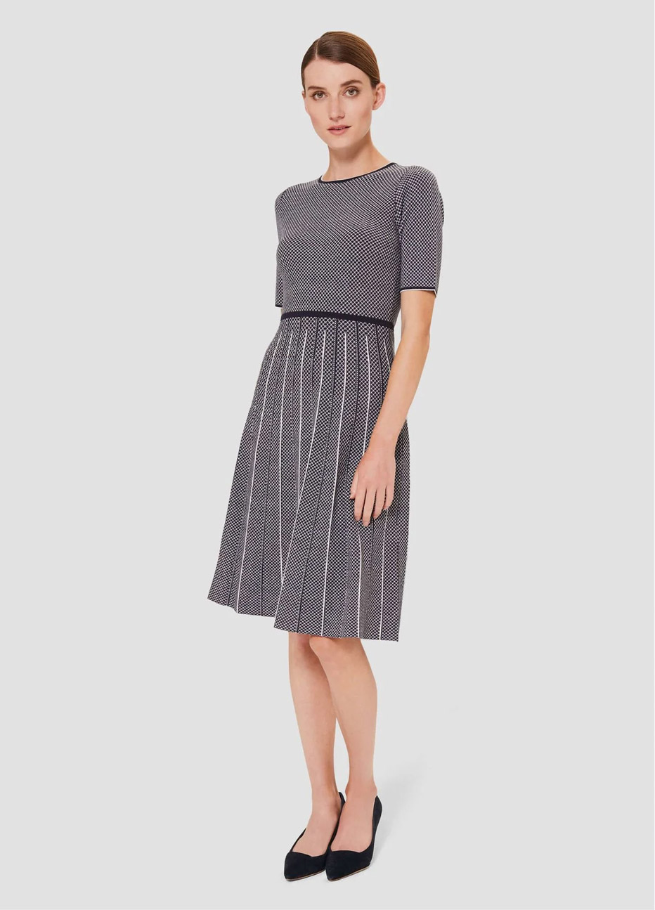 Short-sleeved fit and flare knitted dress in navy with ivory vertical stripes, paired with low heeled black court shoes, by Hobbs.