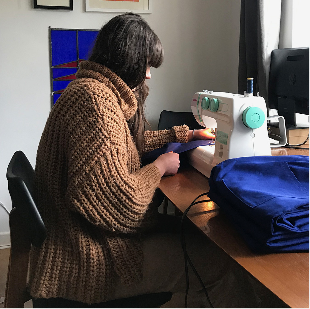 Laura working on a pair of scrubs at home.