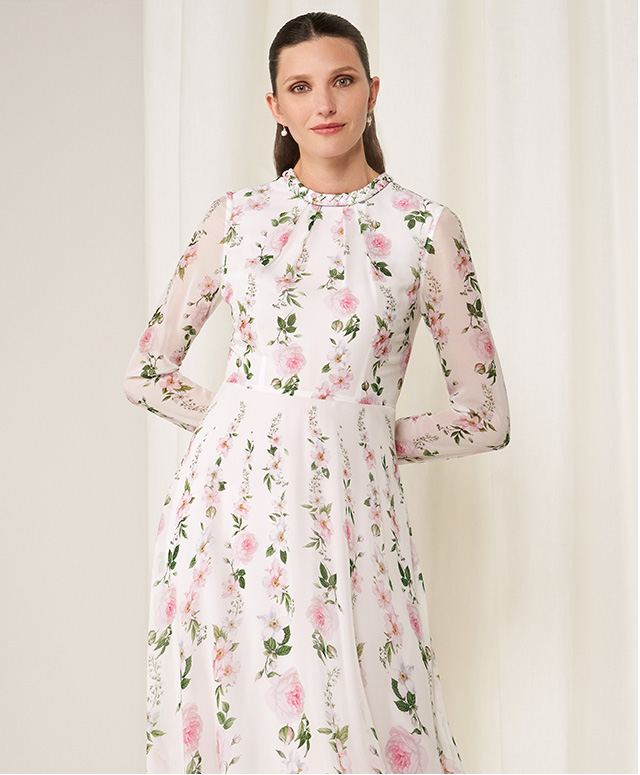 Model photographed wearing Hobbs Rosabelle silk dress with a rose and blossom floral print.