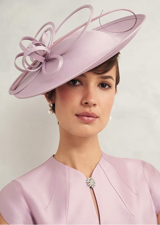 A gallery of four images of models wearing Hobbs fascinators.
