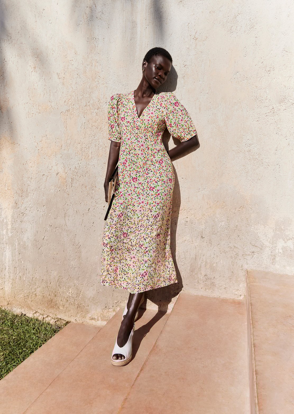 A collage of two images showcasing a model wearing a Hobbs’ ditsy print floral dress.