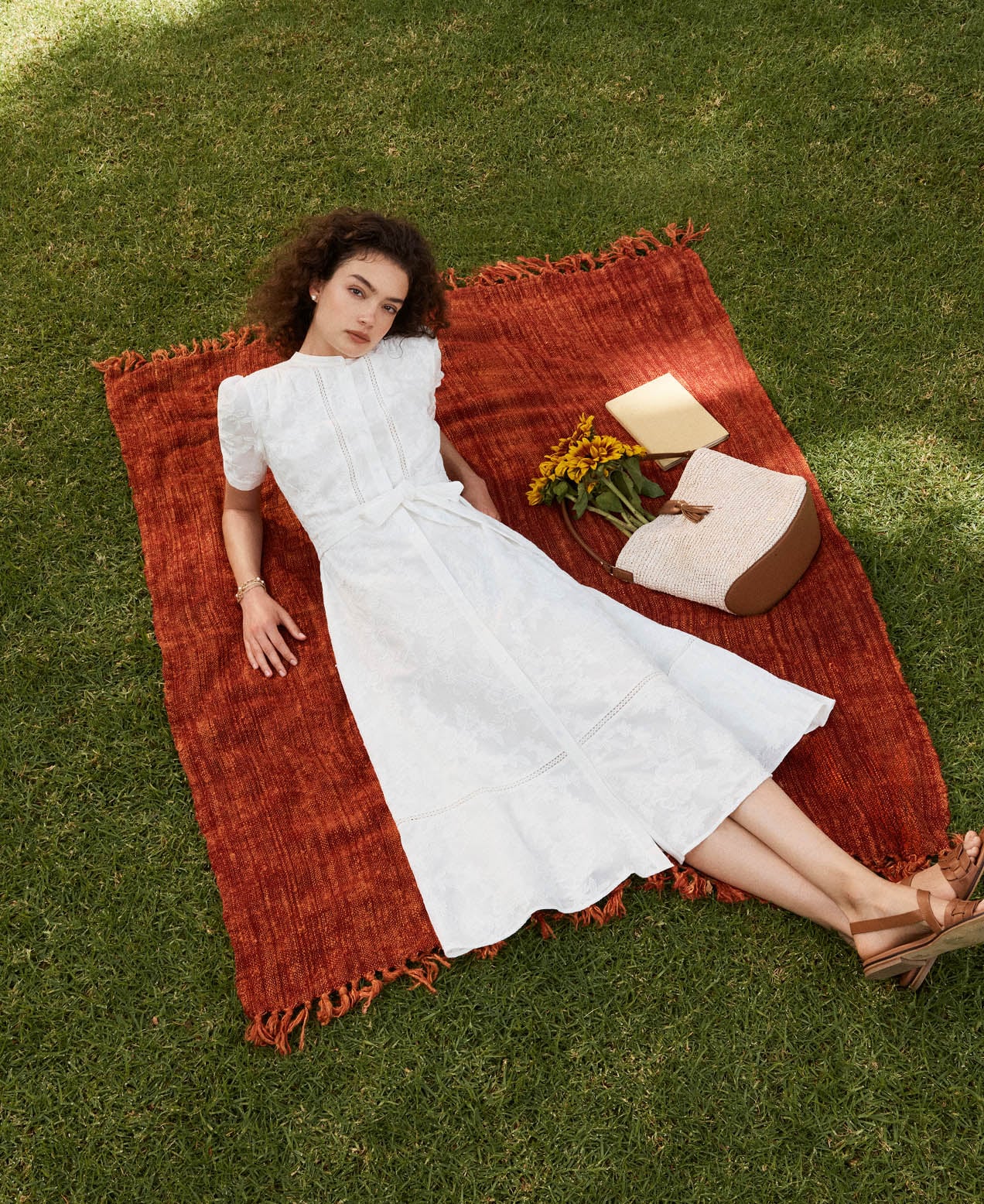 A woman wearing a white Hobbs summer dress.
