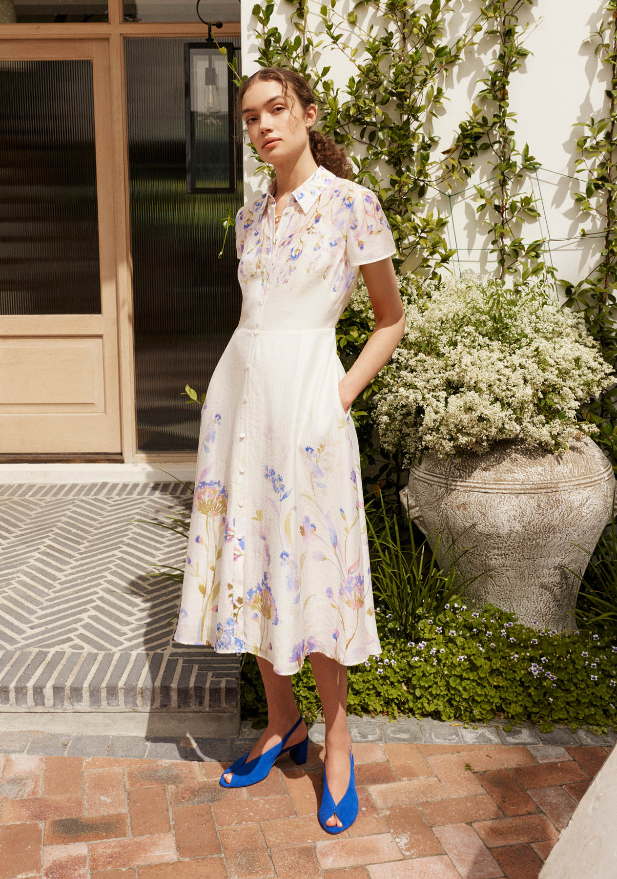 A woman wearing a floral shirt dress.
