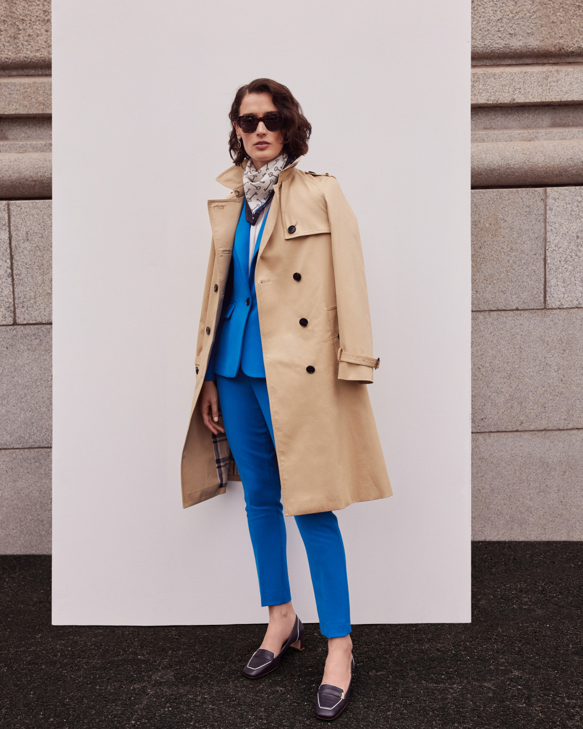 Hobbs model wears a blue trench coat.