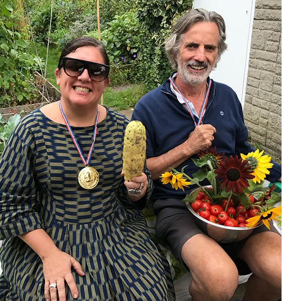 Rosarie and a friend show off the fruits of their hard work in thre allotments