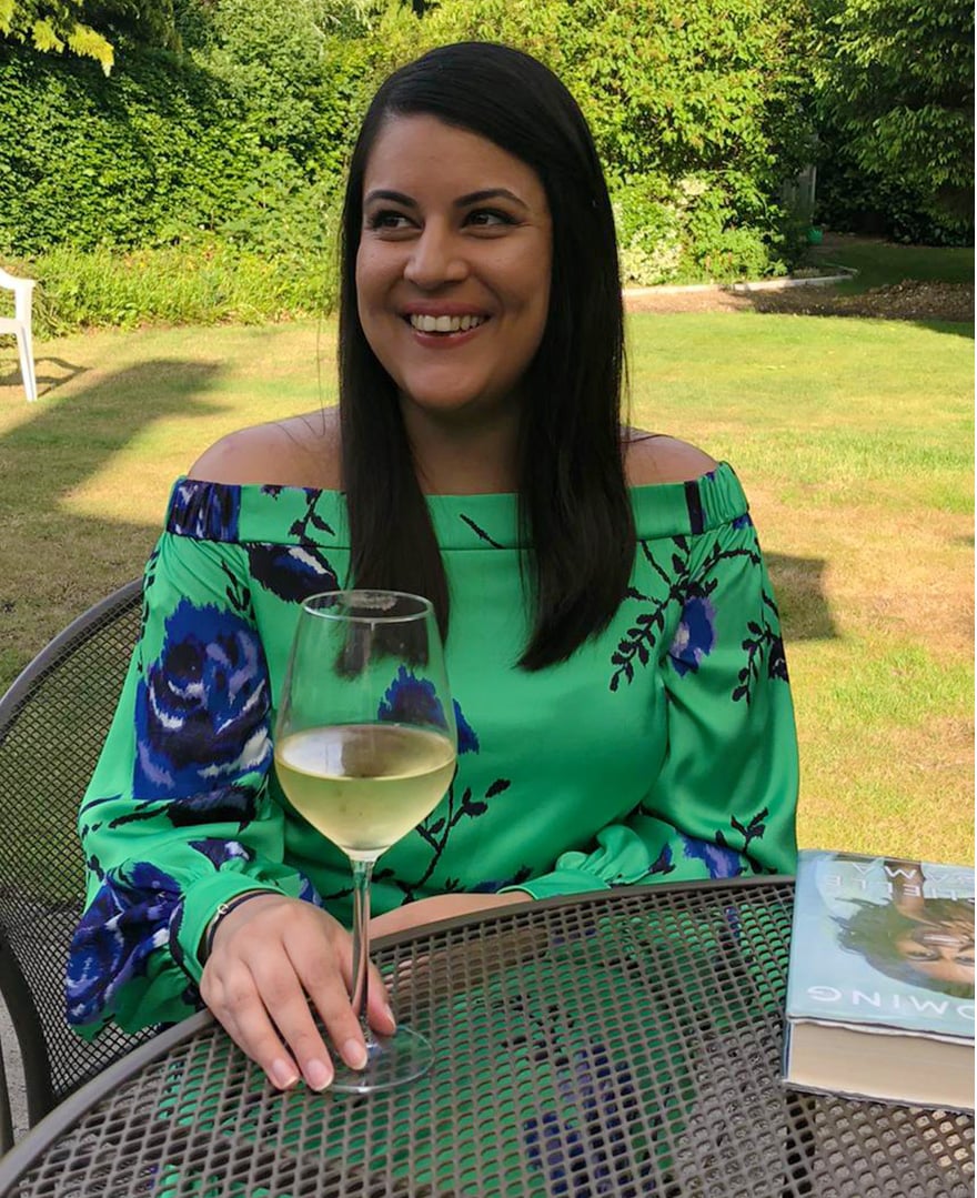 Hobbs junior womenswear buyer, Priya Banwait at home in the Hobbs green off shoulder Miriam dress